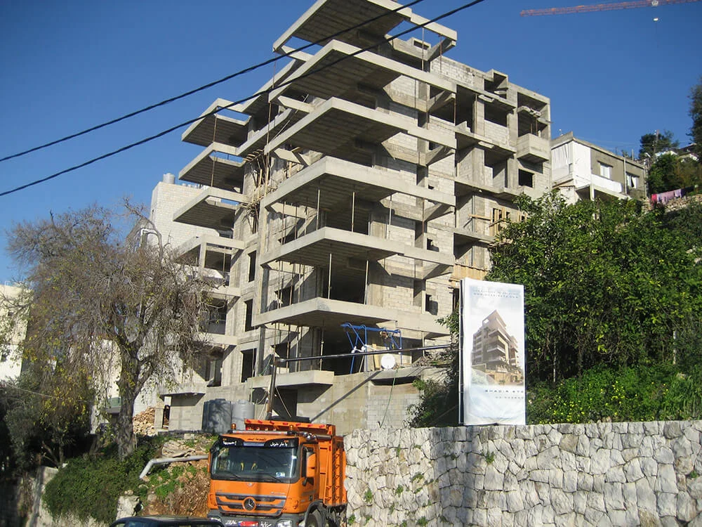 Full building structure with project signage